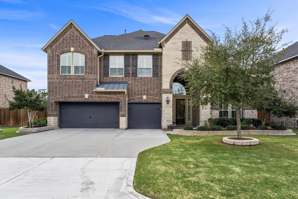 27626 Long Cliff Ln, Spring, TX 77386 - view of front of house with an attached garage, brick siding, stone siding, driveway, and a front yard