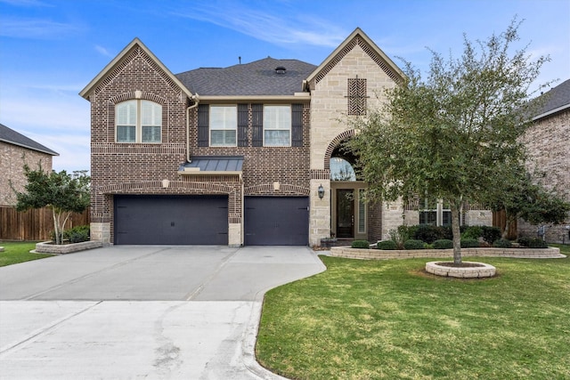 view of front of house with an attached garage, brick siding, stone siding, driveway, and a front yard