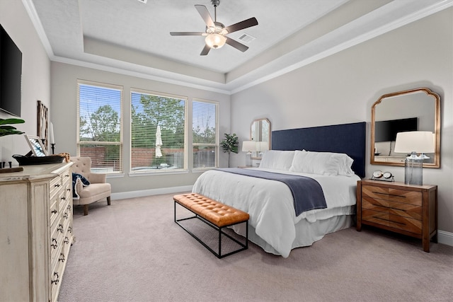 bedroom with light carpet, a raised ceiling, visible vents, and baseboards