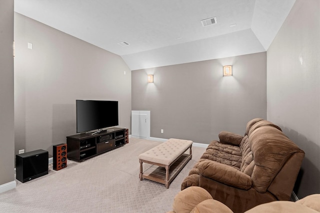 living area with light colored carpet, lofted ceiling, visible vents, and baseboards