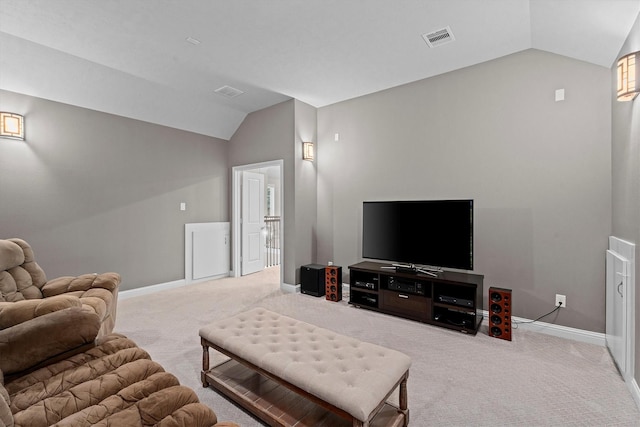 carpeted living room featuring baseboards, visible vents, and vaulted ceiling