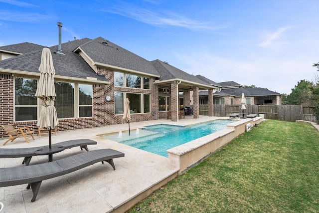 view of swimming pool featuring a yard, a patio, a fenced backyard, and a pool with connected hot tub