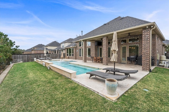 view of swimming pool with a patio, a fenced backyard, a ceiling fan, a yard, and a fenced in pool