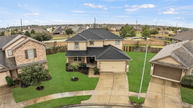 view of front of home with driveway, a garage, a residential view, roof with shingles, and a front lawn