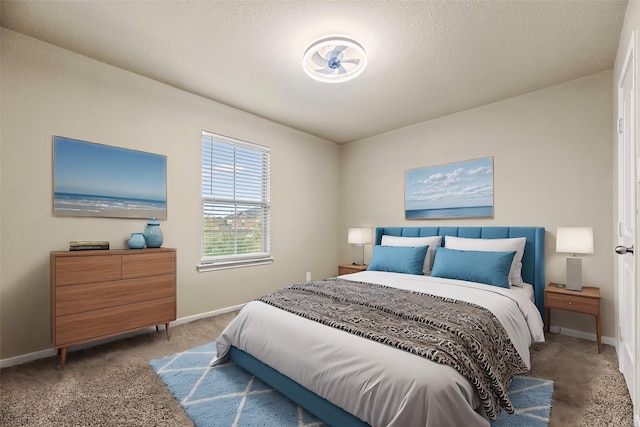 carpeted bedroom featuring baseboards and a textured ceiling