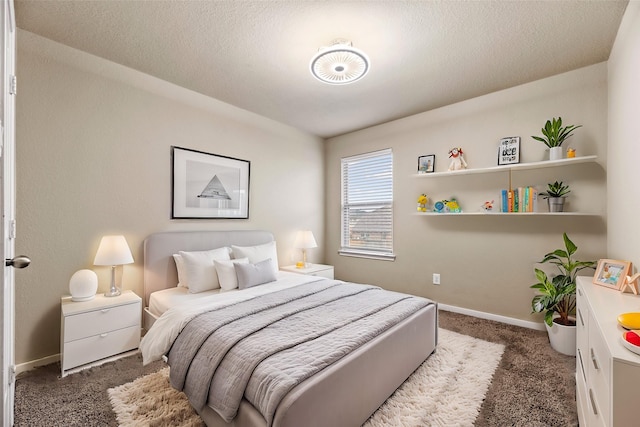 bedroom with carpet, baseboards, and a textured ceiling