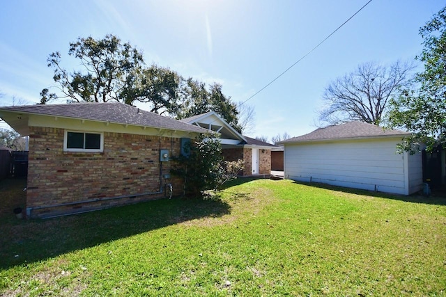 back of property featuring brick siding and a lawn