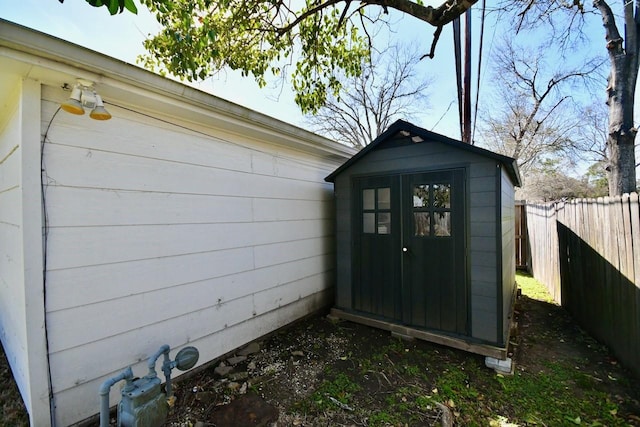 view of shed featuring fence