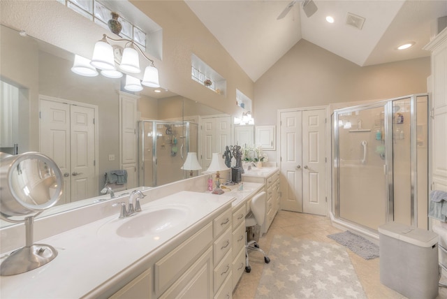 bathroom featuring high vaulted ceiling, vanity, visible vents, a shower stall, and tile patterned floors