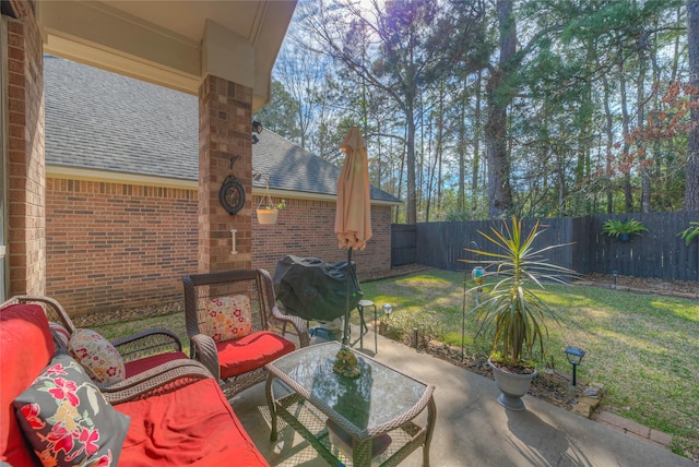 view of patio featuring a fenced backyard and a grill