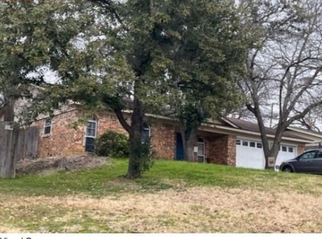 view of front of home with a garage and a front yard