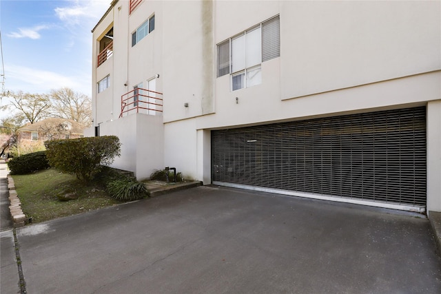 exterior space with a garage and aphalt driveway