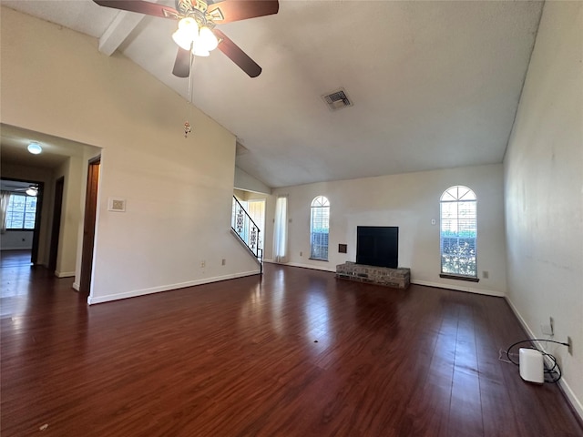 unfurnished living room with stairs, a fireplace, dark wood finished floors, and visible vents