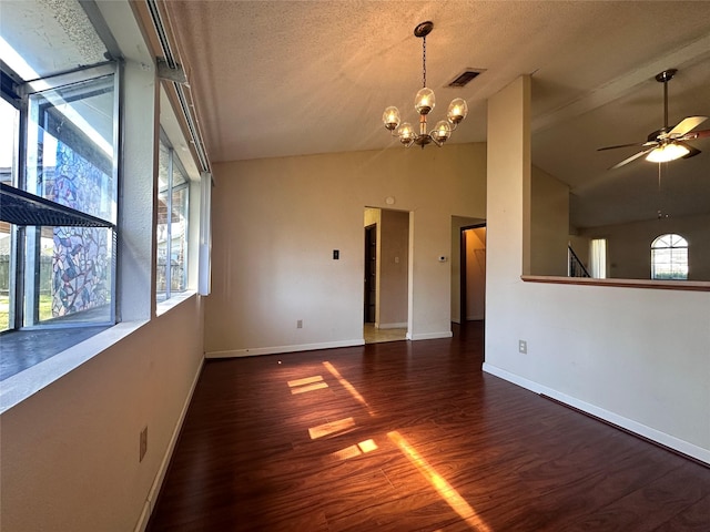 spare room with lofted ceiling, visible vents, baseboards, and wood finished floors