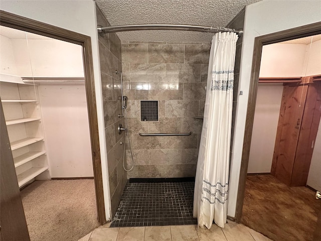 full bath with a stall shower, visible vents, and a textured ceiling