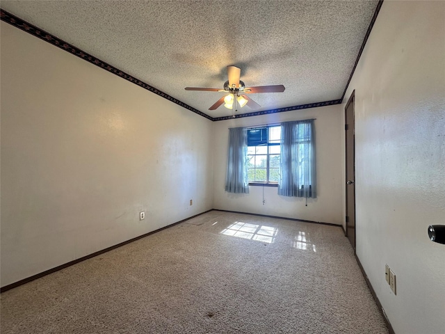 spare room with carpet, crown molding, a textured ceiling, and baseboards