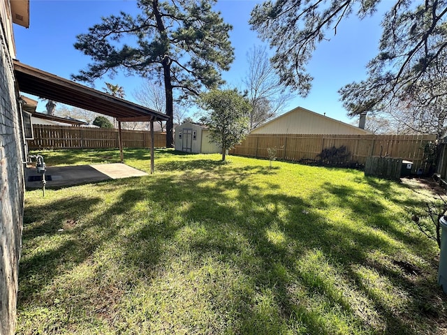 view of yard with a storage shed, a fenced backyard, an outdoor structure, and a patio