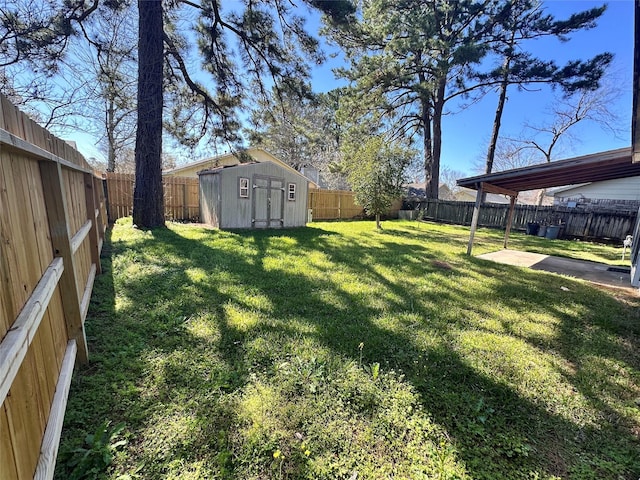 view of yard with a patio area, a shed, an outdoor structure, and a fenced backyard