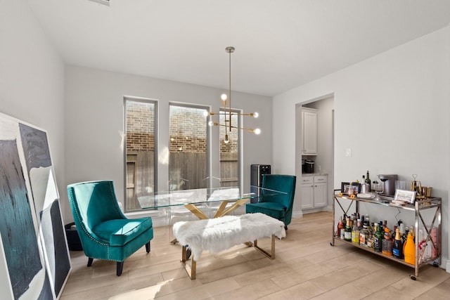 living area with wood finish floors and a notable chandelier