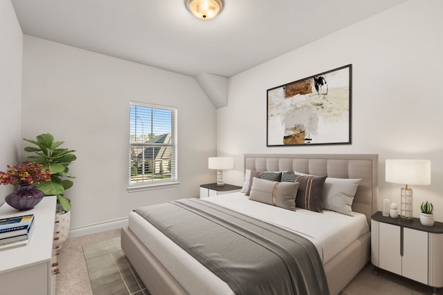 bedroom with baseboards and light colored carpet