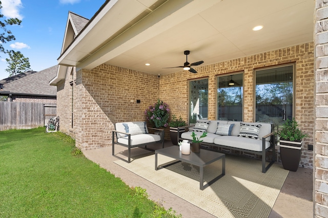 view of patio featuring outdoor lounge area, fence, and a ceiling fan