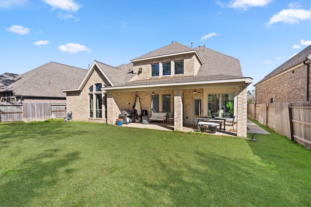 back of property featuring ceiling fan, a lawn, a patio area, and a fenced backyard