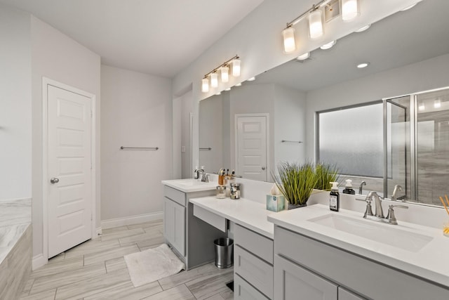 bathroom with a sink, a shower stall, a bathing tub, and double vanity