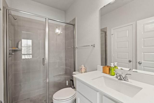 full bathroom featuring toilet, a shower stall, and vanity