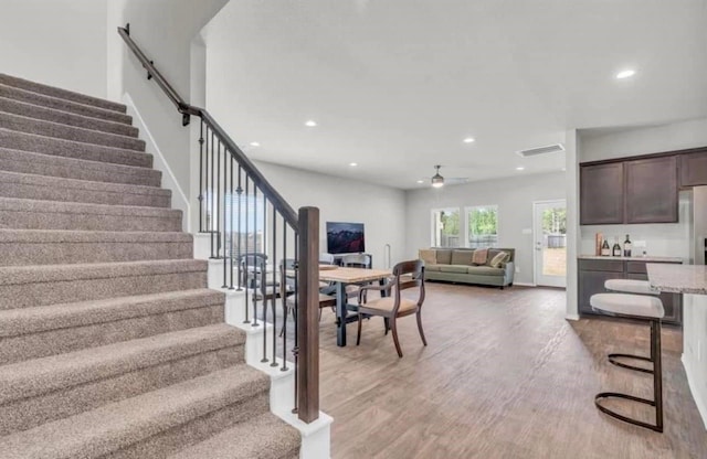 stairway featuring recessed lighting, baseboards, a ceiling fan, and wood finished floors