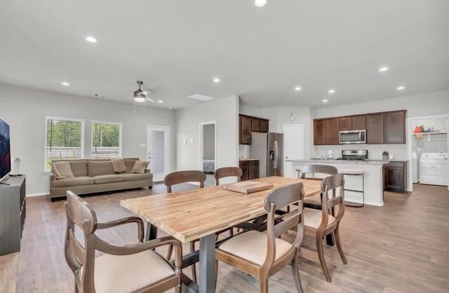 dining space with a ceiling fan, washer / clothes dryer, recessed lighting, and light wood-type flooring