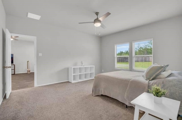 carpeted bedroom with a ceiling fan and baseboards