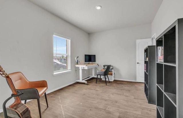 office space featuring light wood-type flooring and baseboards