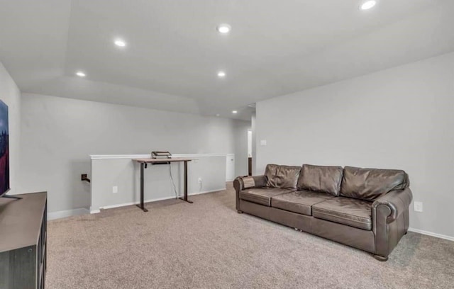 carpeted living area with recessed lighting and baseboards