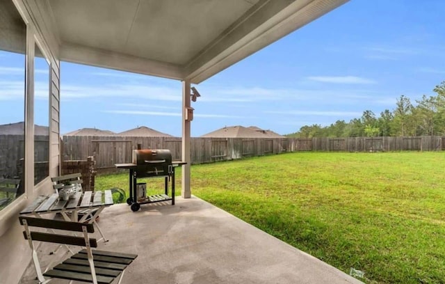 view of patio with grilling area and a fenced backyard