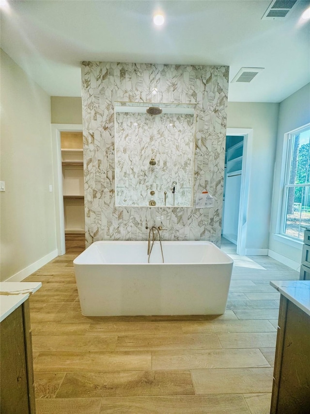 212 Rim Rock Rd, Huntsville, TX 77340 - full bath featuring vanity, wood finished floors, and a freestanding bath