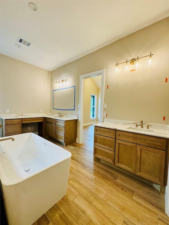 212 Rim Rock Rd, Huntsville, TX 77340 - bathroom featuring a freestanding tub, vanity, and wood finished floors