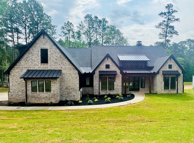 212 Rim Rock Rd, Huntsville, TX 77340 - view of front facade with a standing seam roof, a front yard, and brick siding