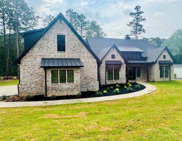 212 Rim Rock Rd, Huntsville, TX 77340 - view of front of house with a standing seam roof, a front yard, brick siding, and metal roof