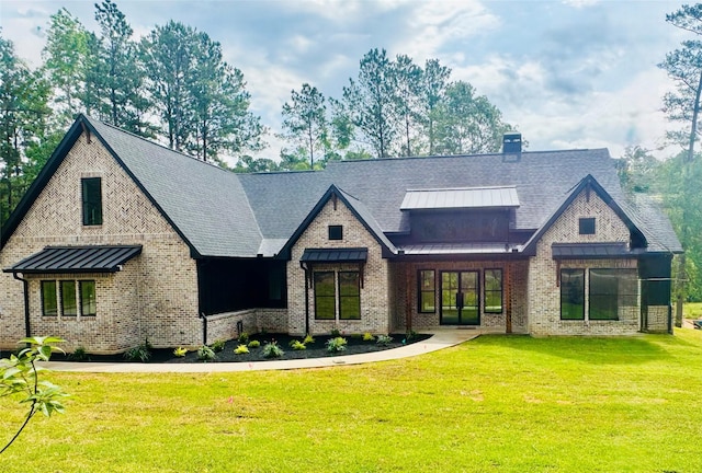 212 Rim Rock Rd, Huntsville, TX 77340 - view of front facade featuring a standing seam roof, a front lawn, metal roof, and brick siding