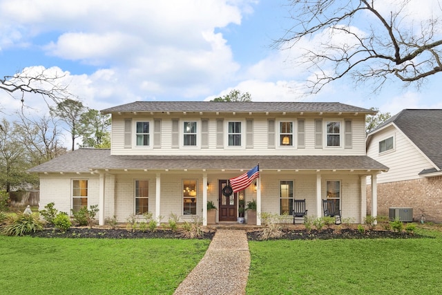 view of front of house with brick siding, a porch, central AC, and a front yard