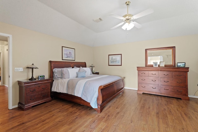 bedroom featuring wood finished floors, visible vents, and baseboards