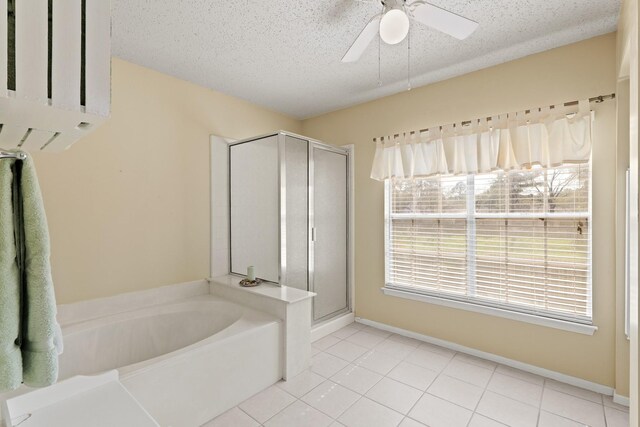 full bathroom featuring a garden tub, ceiling fan, a shower stall, a textured ceiling, and tile patterned floors