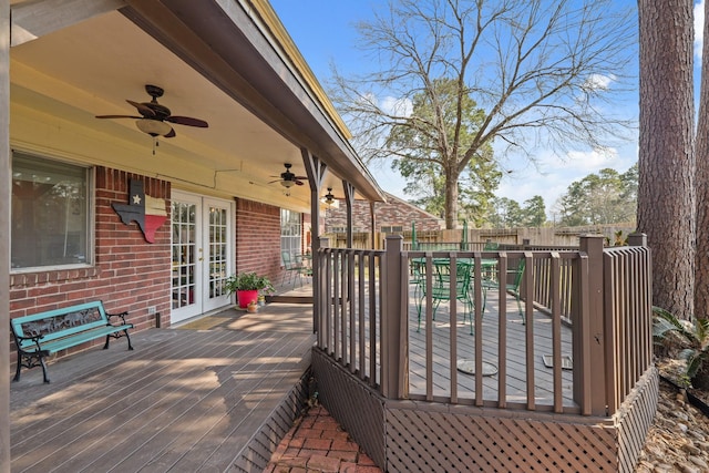 deck featuring ceiling fan, french doors, and fence