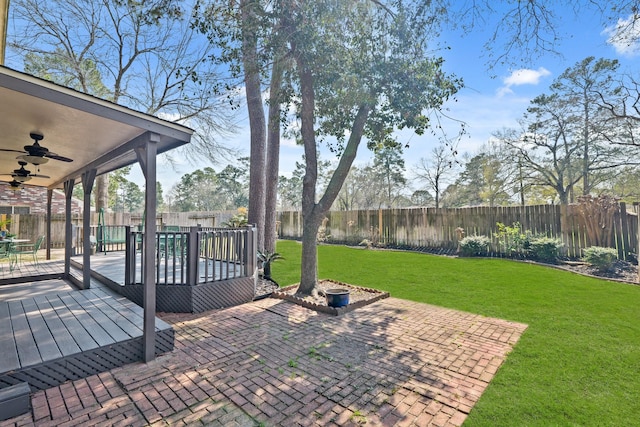 view of patio featuring ceiling fan, a deck, and a fenced backyard