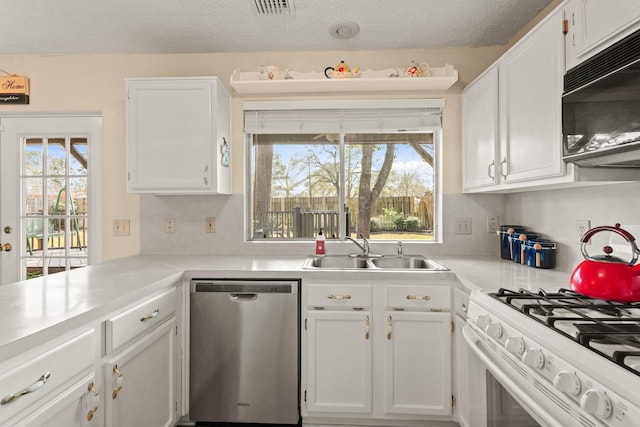 kitchen with black microwave, a sink, white cabinets, white range with gas cooktop, and stainless steel dishwasher