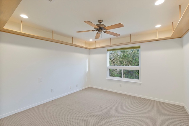 unfurnished room with recessed lighting, light colored carpet, baseboards, and ceiling fan