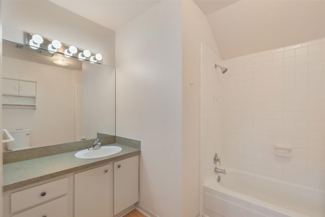 bathroom with vanity, tub / shower combination, and baseboards