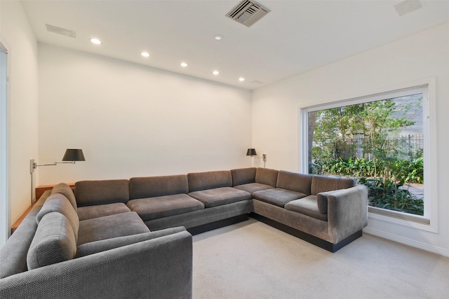 living area with light carpet, visible vents, recessed lighting, and baseboards