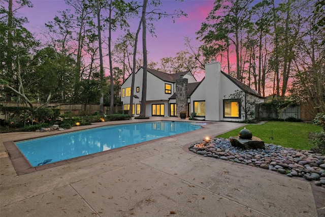 view of pool with a fenced in pool, a lawn, a patio, and fence