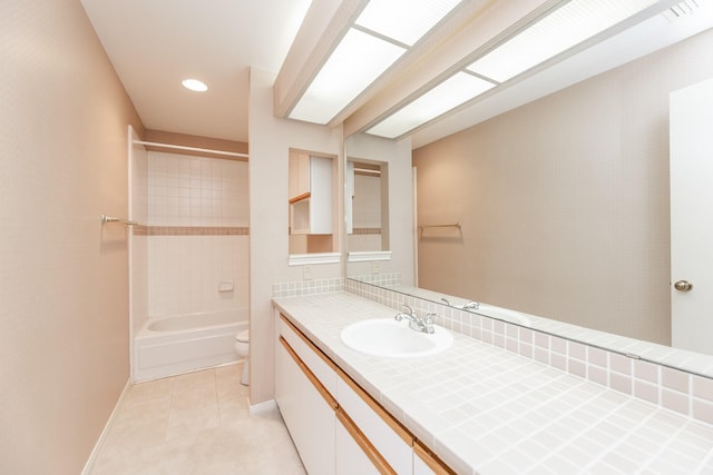 full bath featuring toilet, bathing tub / shower combination, baseboards, vanity, and tile patterned floors